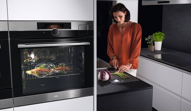 woman cooking in aeg kitchen